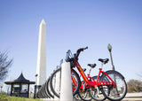 Row of red bikes in front of the Washington monument