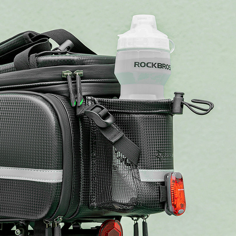 ROCKBROS 34L bike rack bag with water bottle holder and light attachment feature.