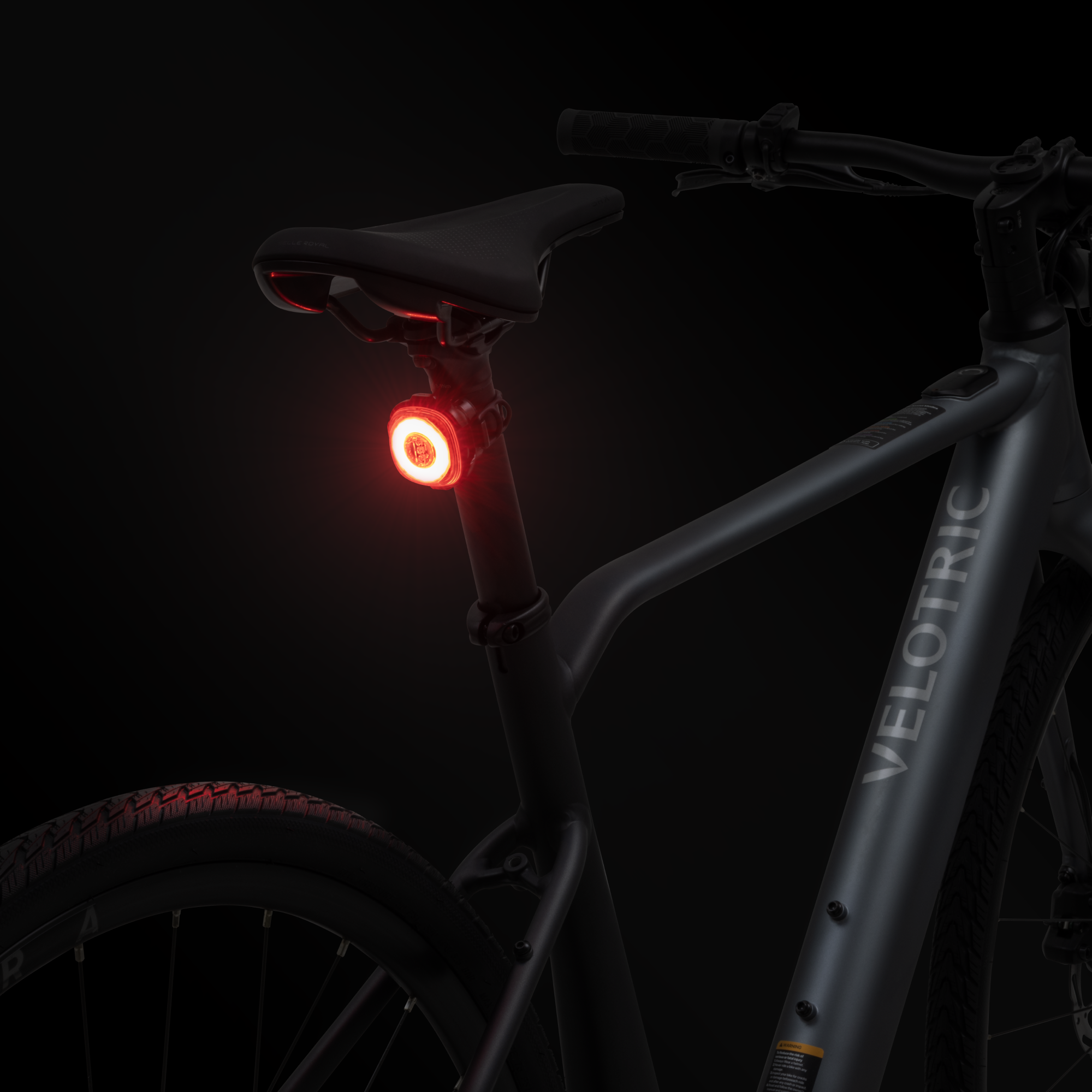 Lumos Firefly Smart Light in red mounted on Velotric e-bike seat post