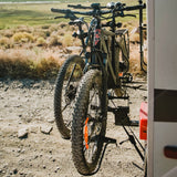 Two electric bikes secured on RV Rider E-Bike Rack against a scenic backdrop